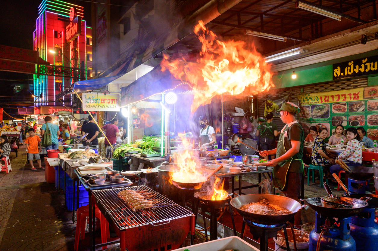 Chef cooking food at street side restaurant in Yaowarat road, Bangkok